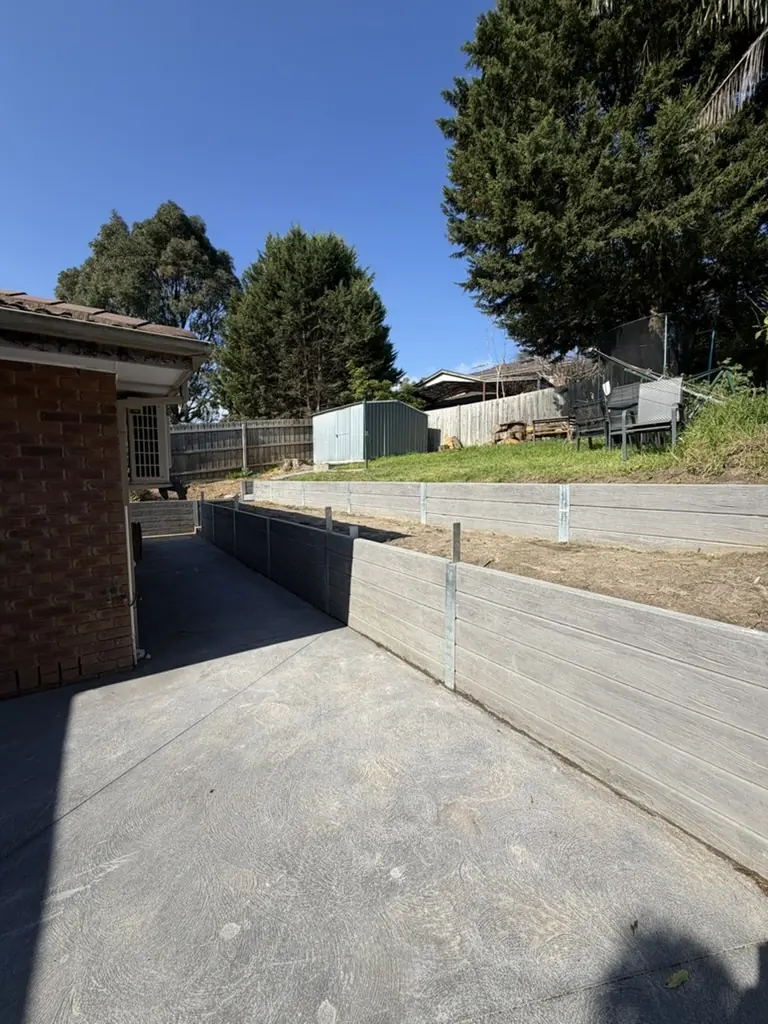 Finished concrete sleeper retaining wall built by CEG